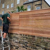 wall top fencing being installed.